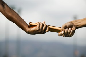 Hands Passing Baton --- Image by © Royalty-Free/Corbis